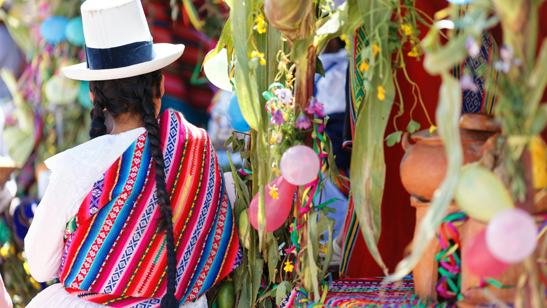Colorful traditional clothing and decorations at a cultural celebration.