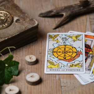 Tarot cards and runes on wooden table