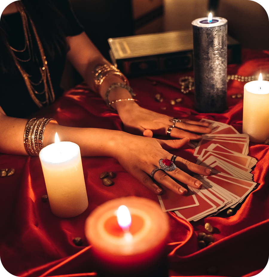 Hands arranging tarot cards on table
